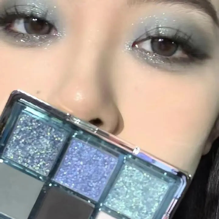 MUGELEEN nine-colour eye shadow palette showing matte and shimmer finishes in blue and smoked tones