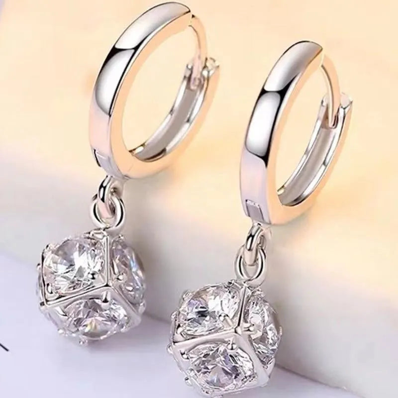 A pair of simple geometric rose-inspired earrings for women, made from electroplated copper, shown in one of the available colour types.