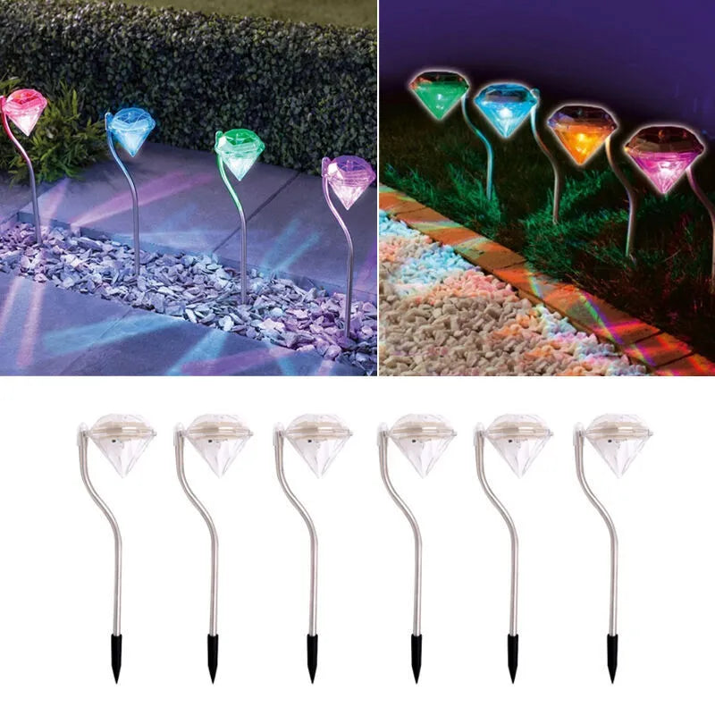 White solar-powered diamond-shaped garden spotlight with adjustable head on a stake.