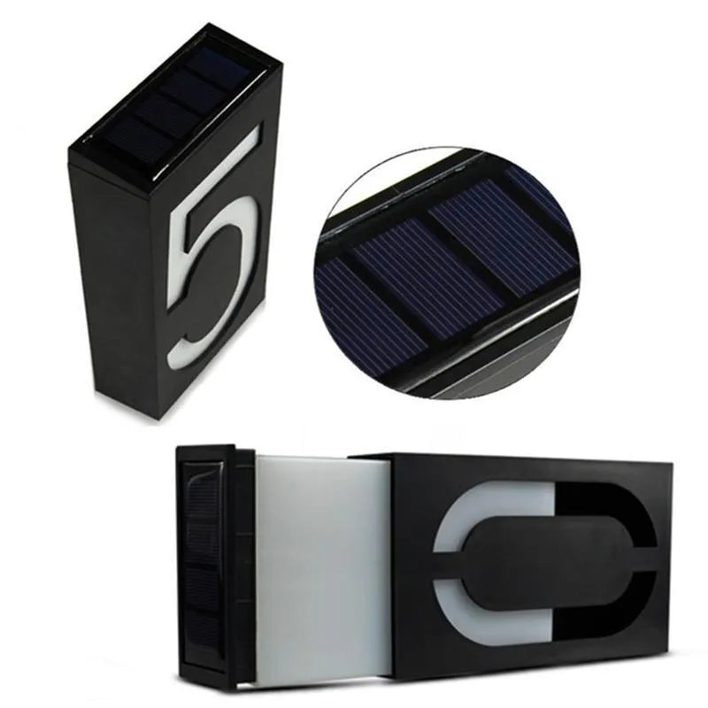 Solar powered outdoor house number light with white LEDs and wall mount.