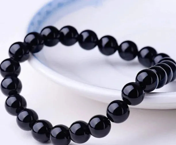 Black agate geometric bracelet with 8mm beads on a black elastic cord for women.