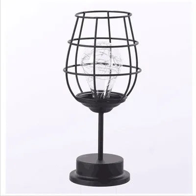 Minimalist hollow iron table lamp in wine glass or bottle design with warm white LED light