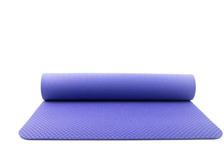 Pure colour EVA yoga brick, thick non-slip mat, and cotton tension band on a floor, in blue, purple, pink, red, black, gray