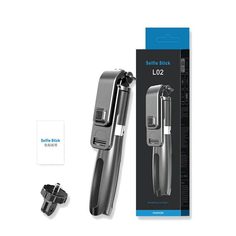 Extended black Bluetooth selfie stick with phone attached and separate wireless remote on a table