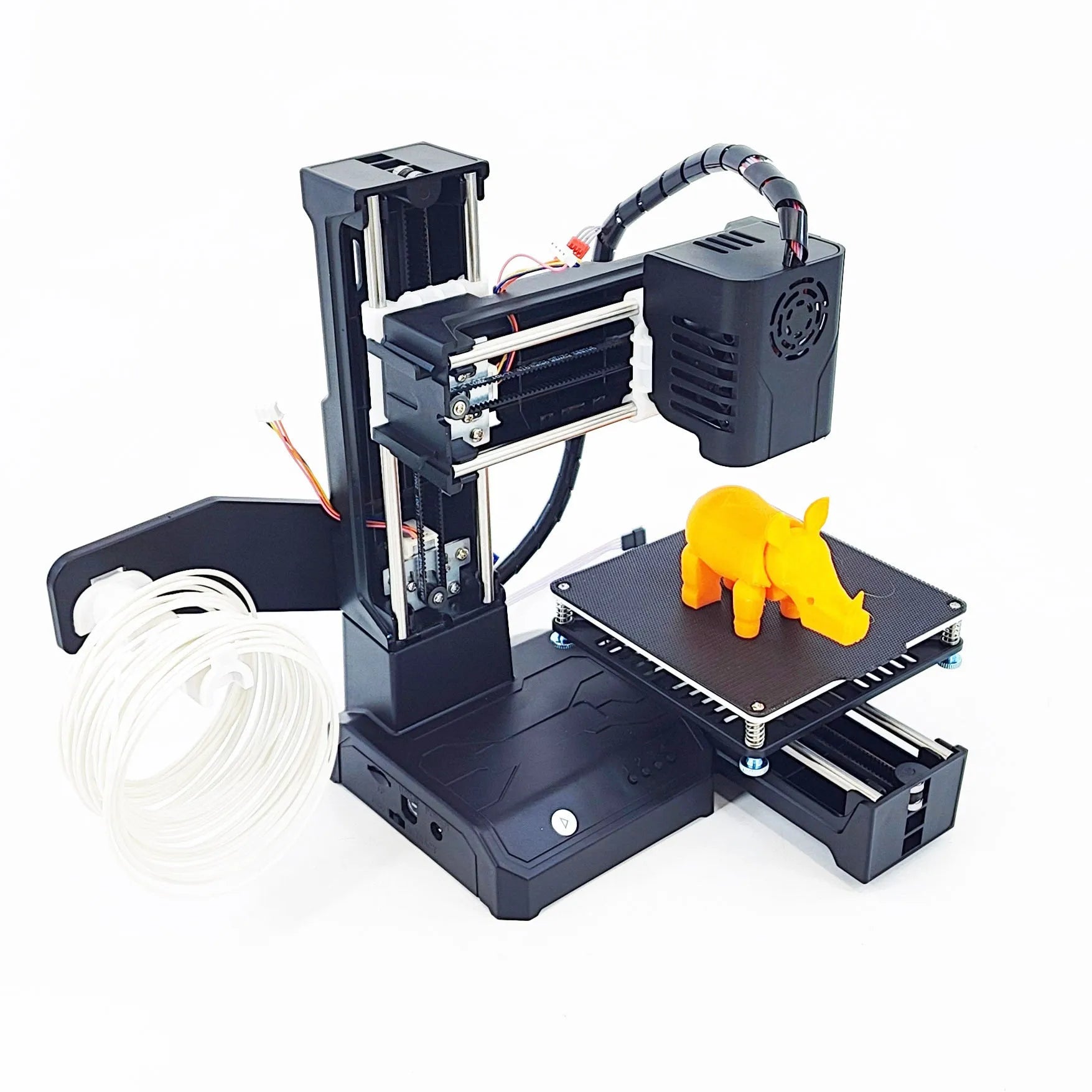 K9 New Mini desktop 3D printer on a table, showing its compact size and build plate.