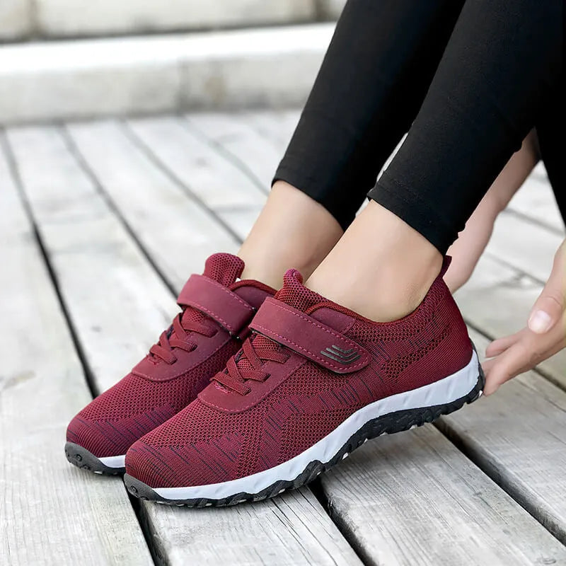 Women's grey purple low-top casual shoes with Velcro strap and wedge heel on a plain background.