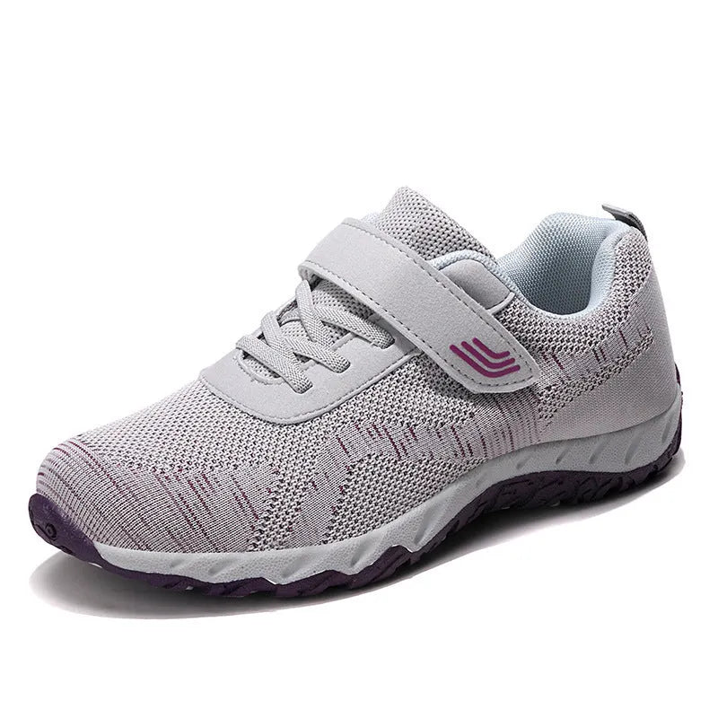 Women's grey purple low-top casual shoes with Velcro strap and wedge heel on a plain background.
