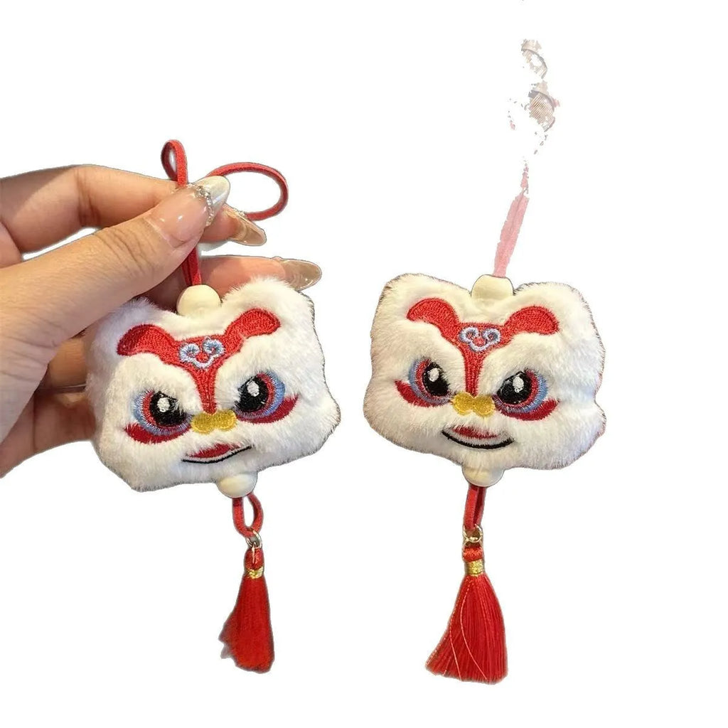 Handmade blue and yellow Chinese style plush lion keychain ornament with star stone decoration.