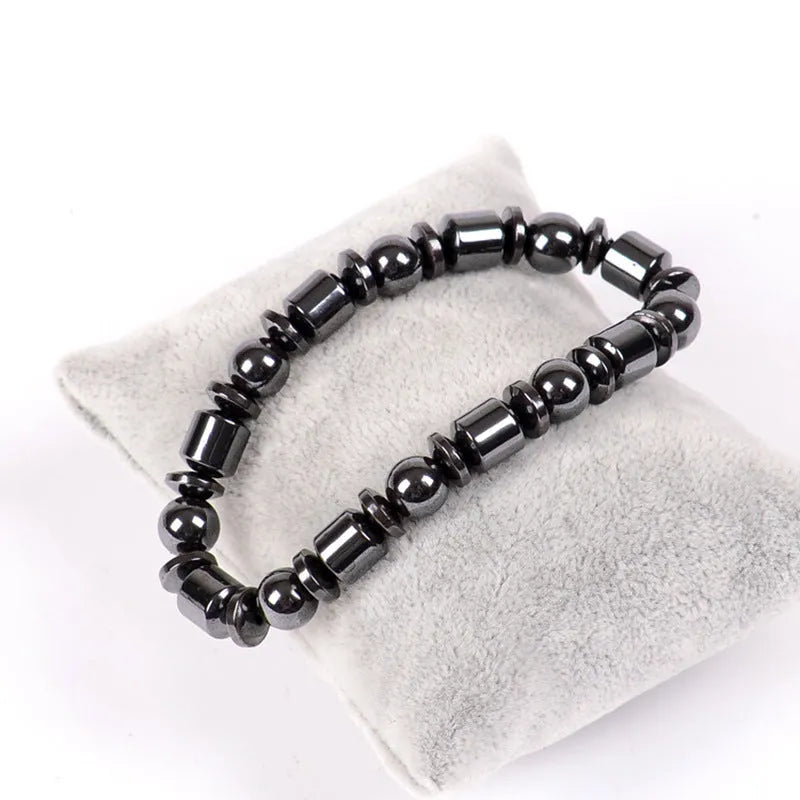 Black pentagram pattern magnetic therapy bracelet with magnetite and hematite stones on a stretch band.