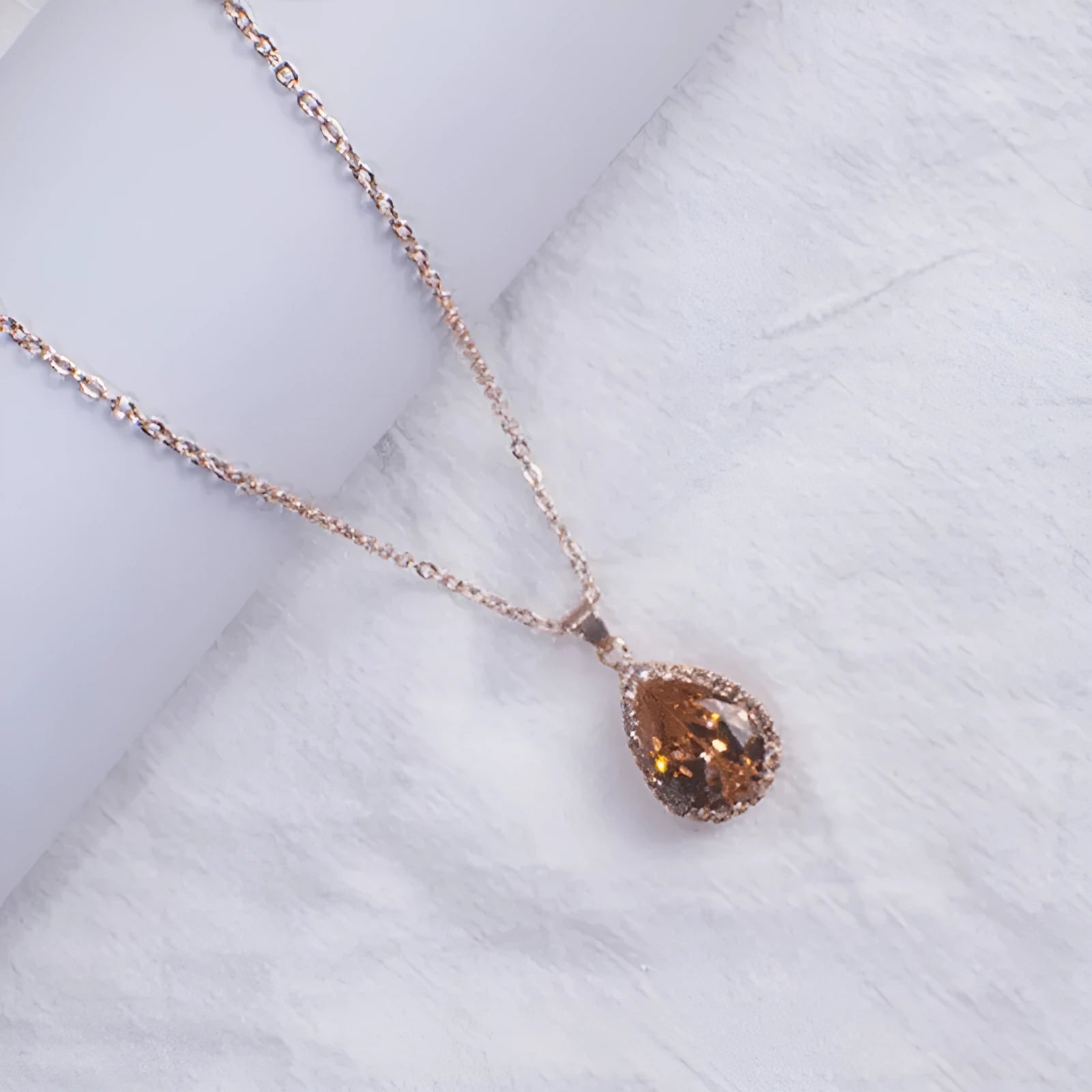 Rose gold geometric drop necklace with rhinestone details in pink colour option