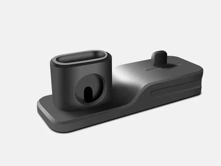 Black silicone 3-in-1 charging base for iPhone, iWatch, and AirPods on a plain surface