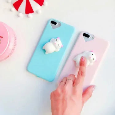 Soft silicone iPhone case with a raised 3D cartoon cat design in pink.