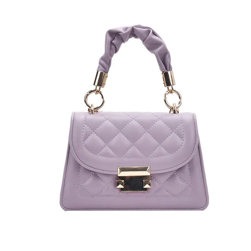Small square purple shoulder bag with rhombus pattern showing crossbody strap and interior compartment.