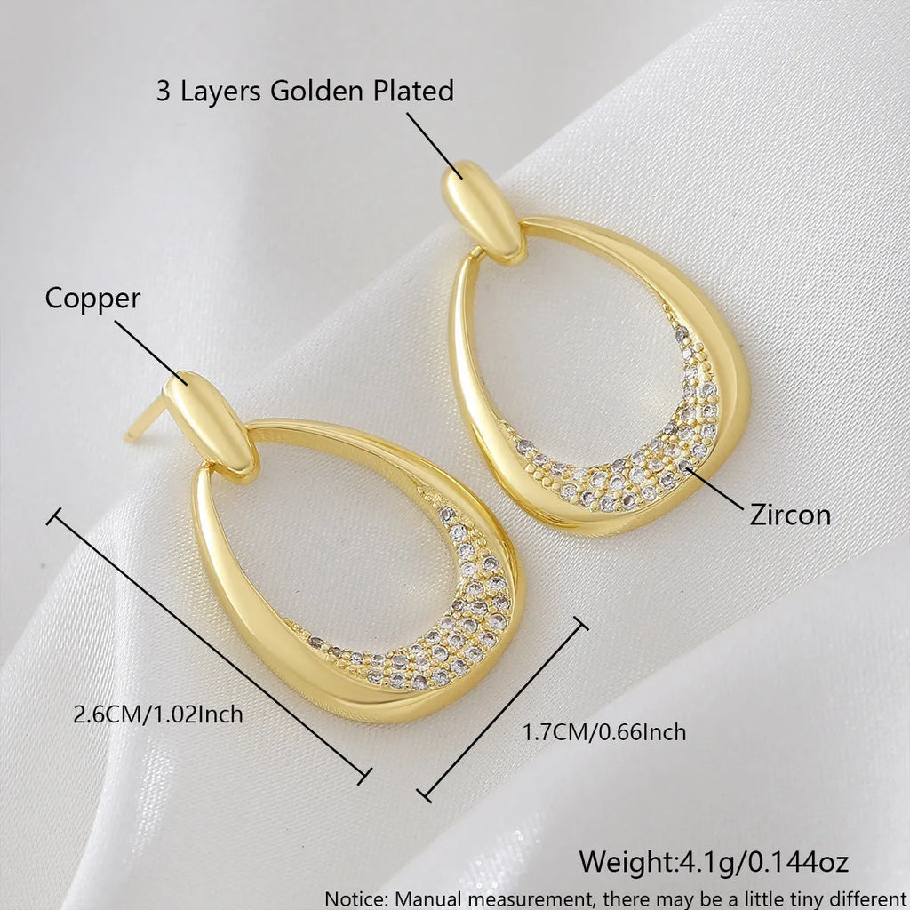 Yellow gold geometric drop earrings with oval shape measuring 2.6 by 1.7 centimetres
