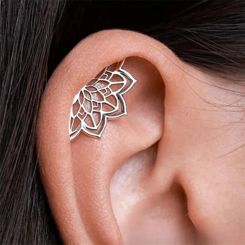 Spider web design stud earrings in gold and silver metal with geometric mesh pattern