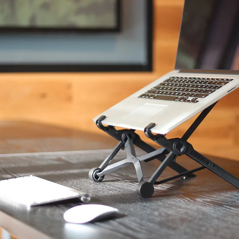 Black folding portable laptop computer stand made from reinforced nylon, shown in both folded and open positions.