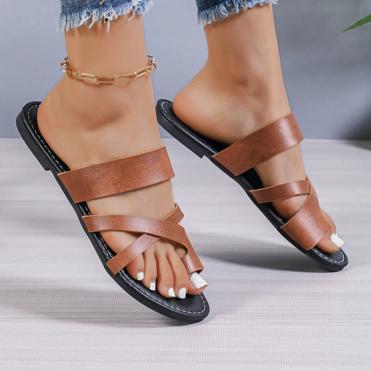 Adult casual beach slipper in black with hollow out design and rubber sole.