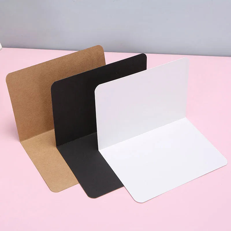 Blank folded kraft card 10x15cm in cowhide colour, packed in a stack of 100 for stationery use