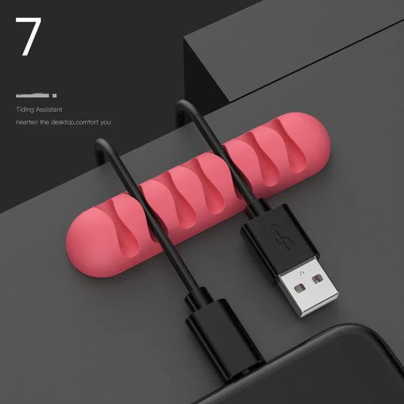 Smart cable holder with TPR flexible clips in black holding USB earphone and network cables on a desk