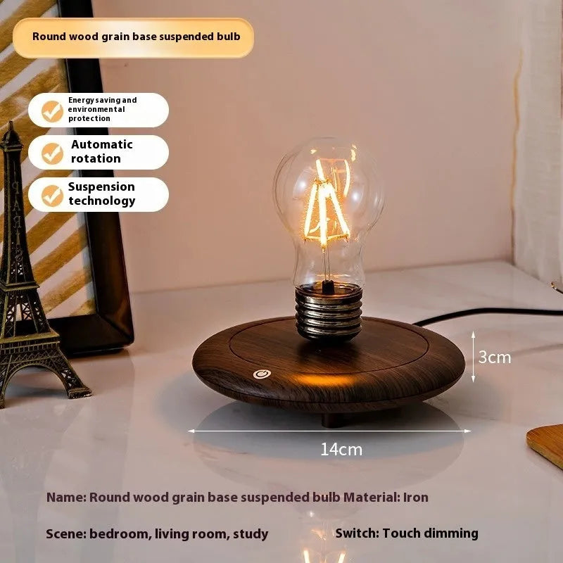 Creative iron art night lamp with a suspended bulb on a black wood grain base.