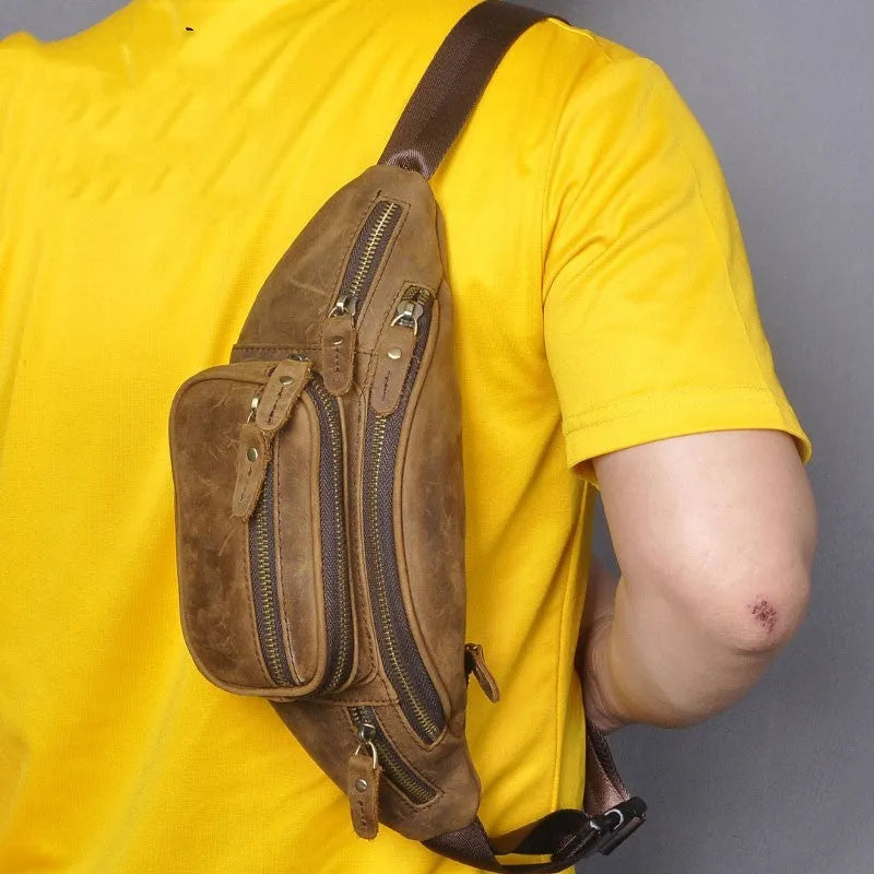 Brown leather shoulder messenger bag with a single strap and magnetic buckle closure.