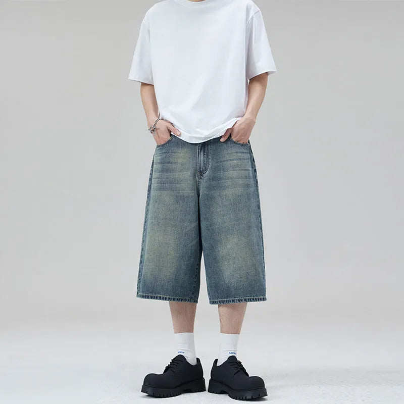 Men's loose straight-leg denim shorts in light blue colour showing cropped length and casual styling