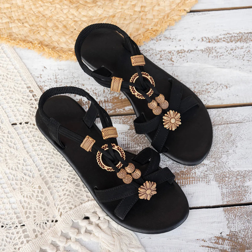 Black ethnic style women's flat sandals with beaded weave and rhinestone decoration on a rubber sole.