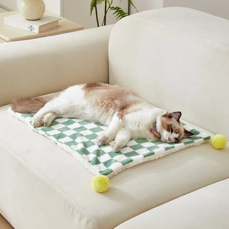 Green plaid pattern plush pet blanket for cats and dogs on a sofa