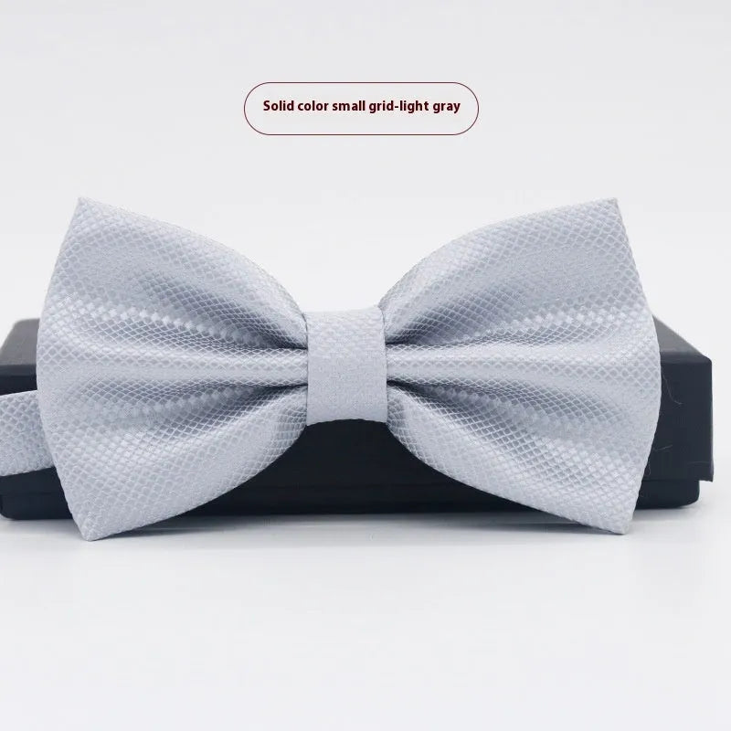 Solid colour flat head bow tie for formal wear in multiple colours including black, red, and blue.