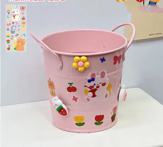 Round metal desktop pen holder showing colour options including green, pink, red, white and yellow