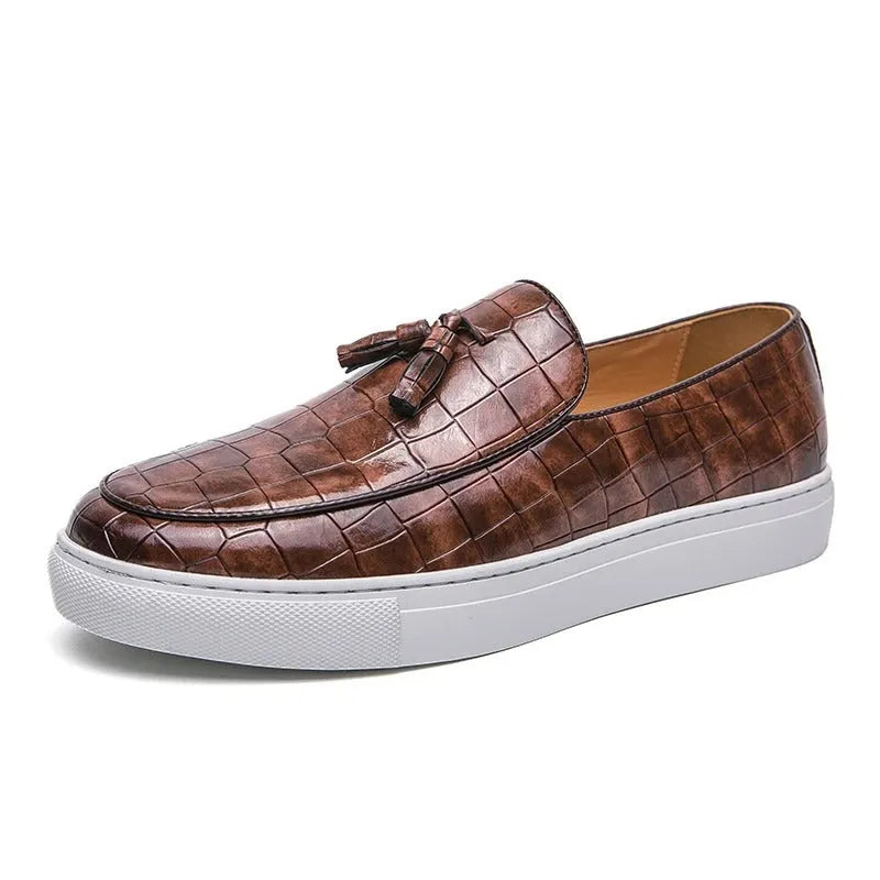 Men's plus size black slip-on sneakers with tassel detail and round toe on a rubber sole.