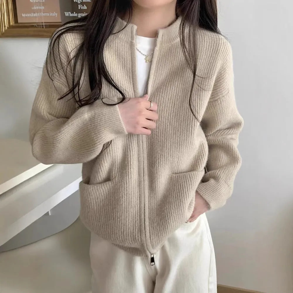 Beige women's long sleeve soft glutinous sweater coat cardigan laid flat.