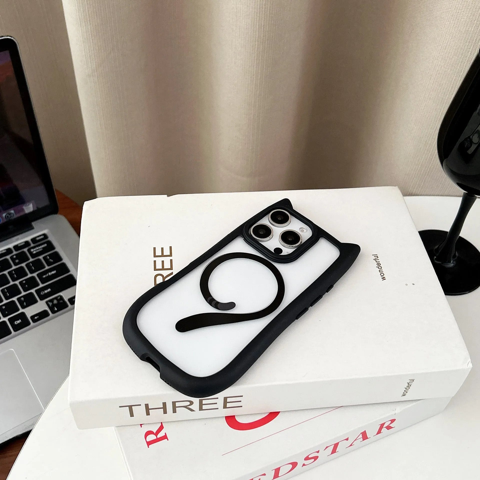 Transparent acrylic and TPU phone case for IPhone 17 with magnetic suction ring on back.