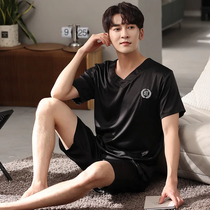Man's light blue ice silk short-sleeve pajama shirt and loose matching shorts laid flat