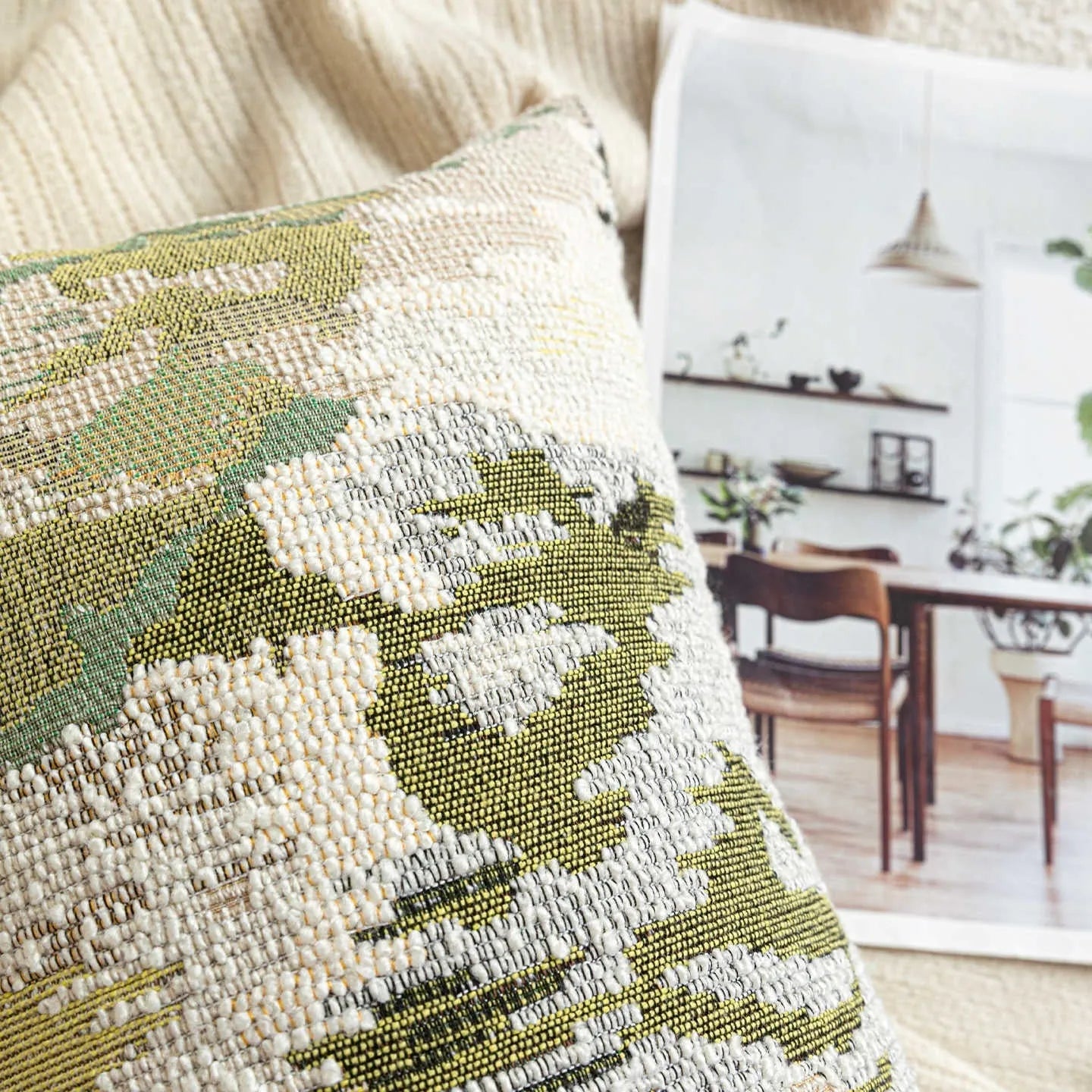 Green abstract floral pattern on a wool blend cushion cover, shown in square and lumbar pillow sizes.