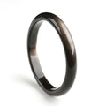 Natural silver stone cat's eye obsidian and alloy ethnic bracelet with geometric patterns on a wrist.