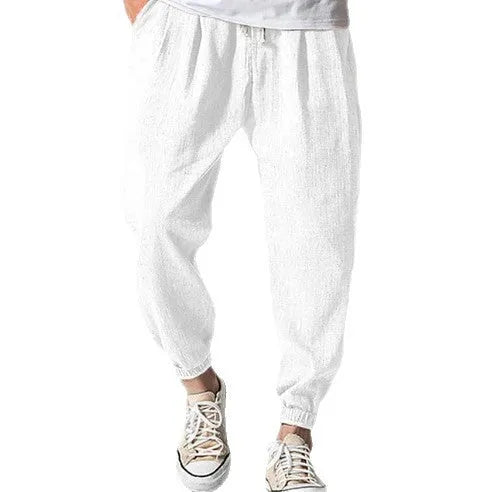 Men's cotton ankle banded trousers in light green colour showing loose fit and summer casual styling