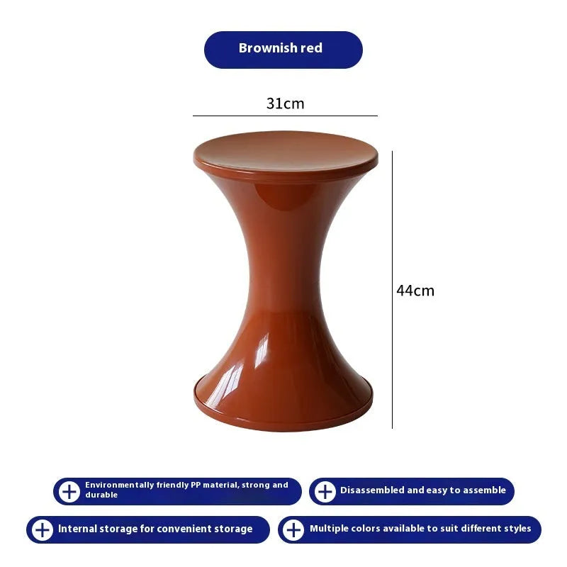 Green hourglass-shaped plastic stool for changing shoes, suitable for children and adults.