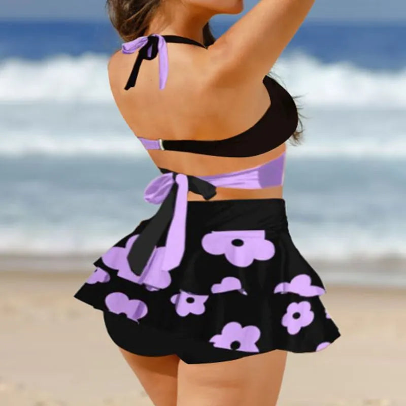Women's purple bikini set with matching skirt showing lace-up detailing and high-waist styling