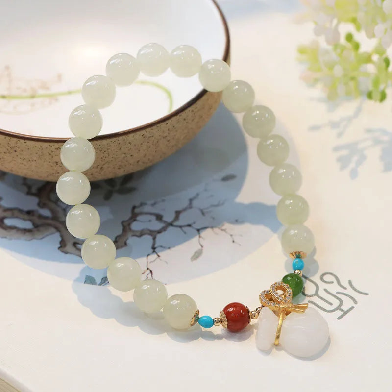 8mm natural Hetian gray jade round bead bracelet on women's wrist, retro style