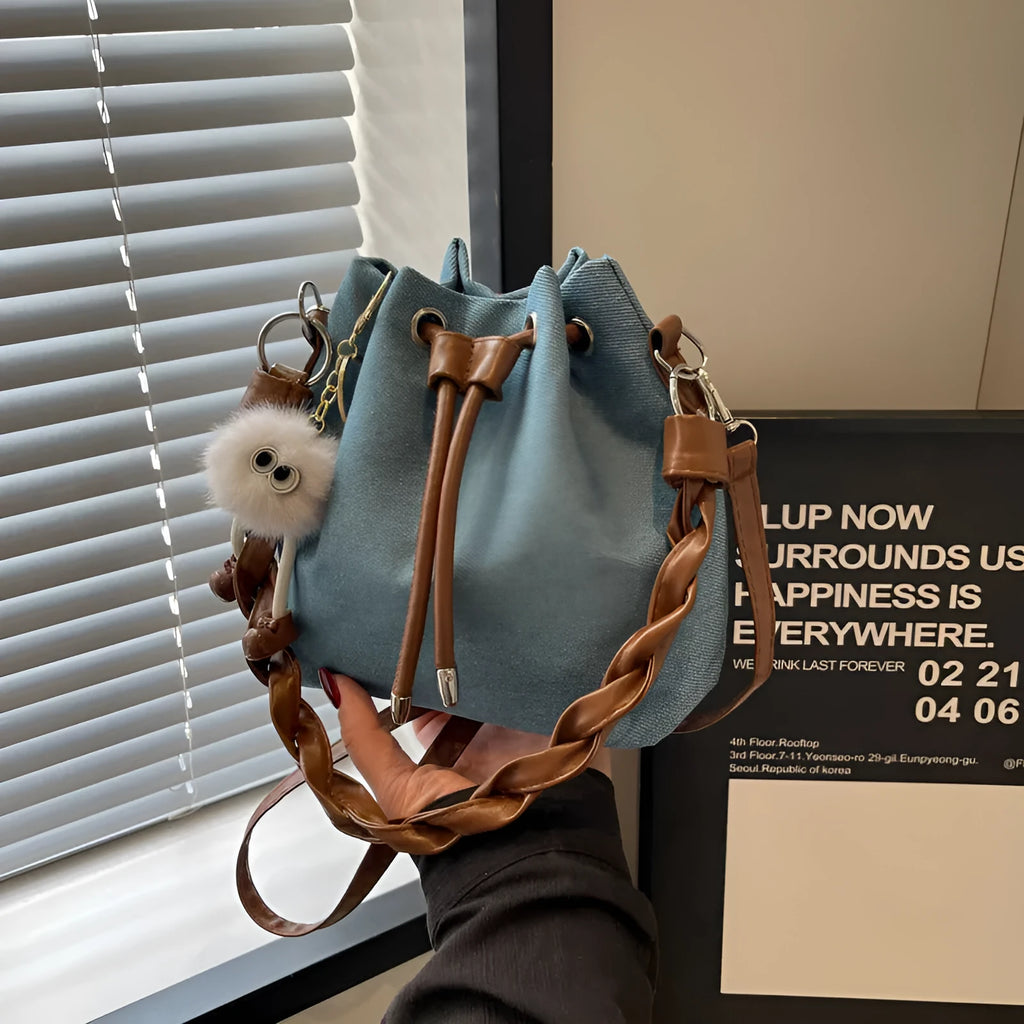 Blue cross body bucket messenger bag with synthetic leather lining and sandwich pocket organisation
