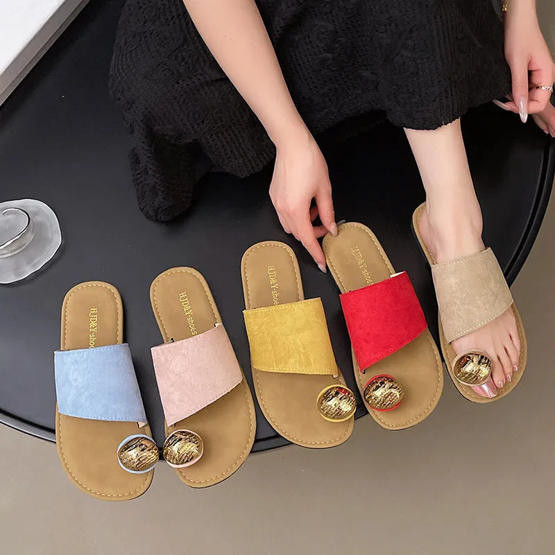 Women's flat bottomed French toe flip flops in solid colours on a light background
