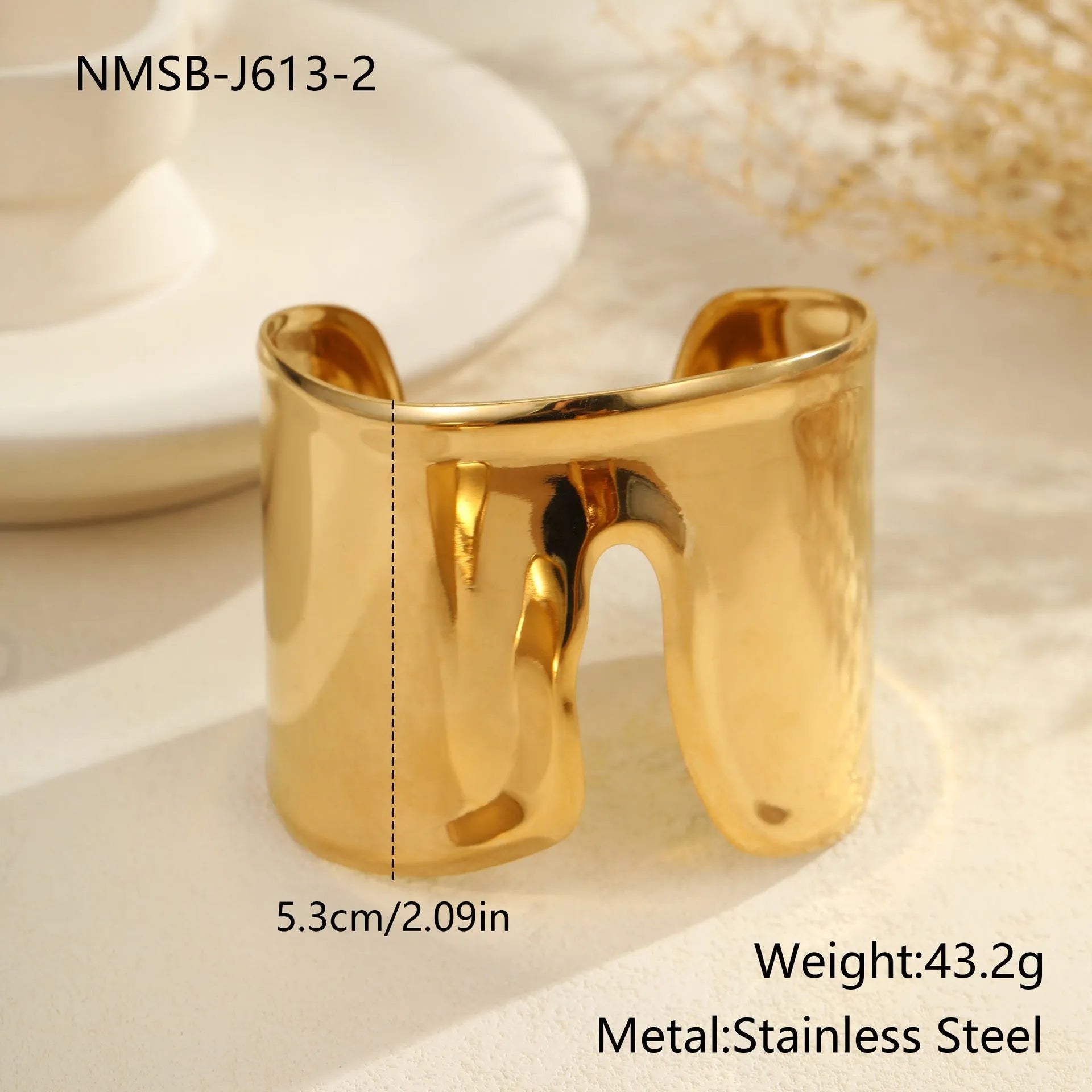 Women's gold-plated wide bracelet with stainless steel construction and geometric design