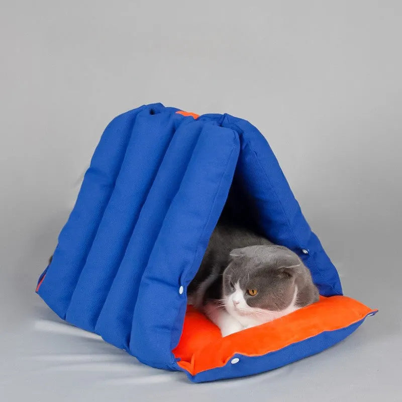 Blue triangular sofa-shaped cat nest with drilled holes for combination, showing removable cotton cover.
