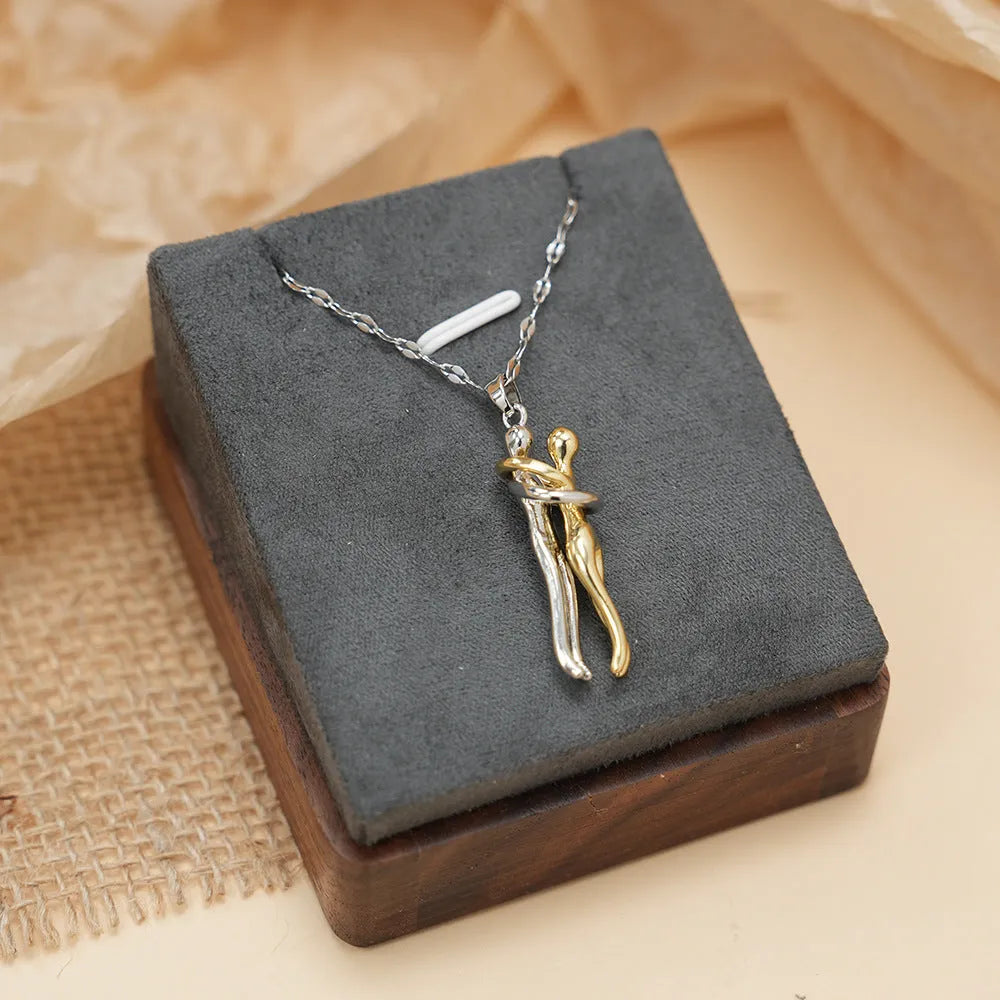 Couple hugging bronze pendant necklace on unisex stainless steel chain with gold lip chain finish, casual style