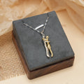 Couple hugging bronze pendant necklace on unisex stainless steel chain with gold lip chain finish, casual style