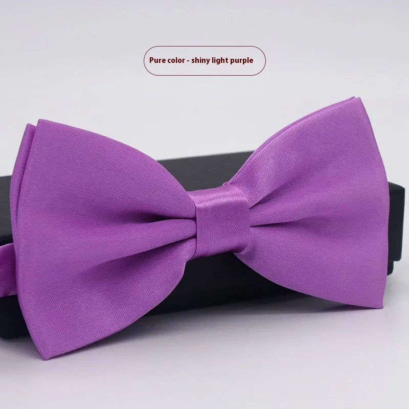 Solid colour flat head bow tie for formal wear in multiple colours including black, red, and blue.