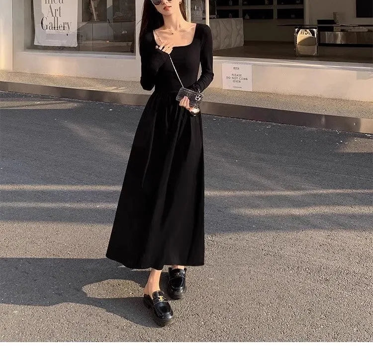 Women's black knitted dress with square collar, long sleeves, elastic waist, and A-line floor-length skirt
