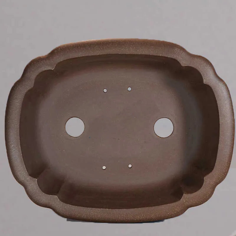 Handmade purple clay rectangular flower pot with antique finish on desktop