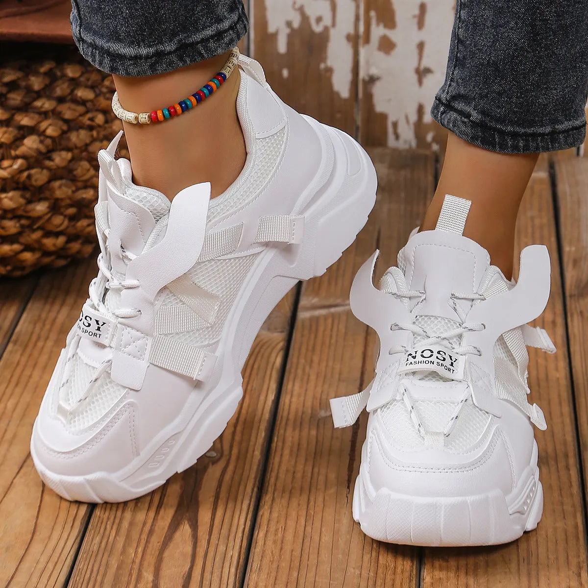 Women's platform mesh dad sports trainer in animal pattern, showing lace-up front and height-increasing sole.